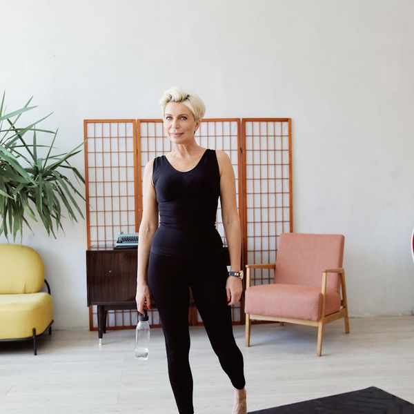 Yoga mat, water bottle and comfortable clothes neatly arranged for a session.